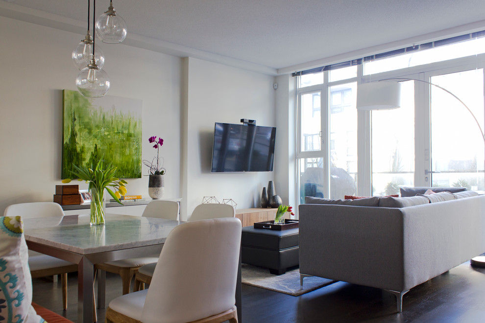 Example of a small minimalist open concept dark wood floor living room design in Vancouver with white walls and a wall-mounted tv