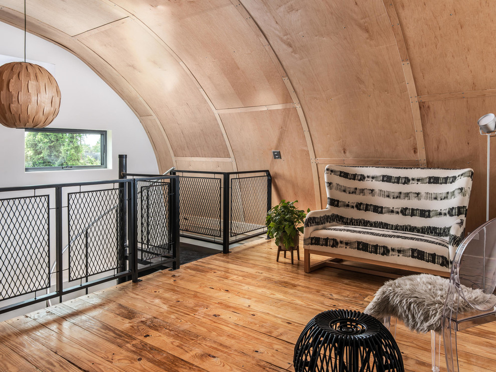 Example of a small urban loft-style light wood floor living room design in Nashville