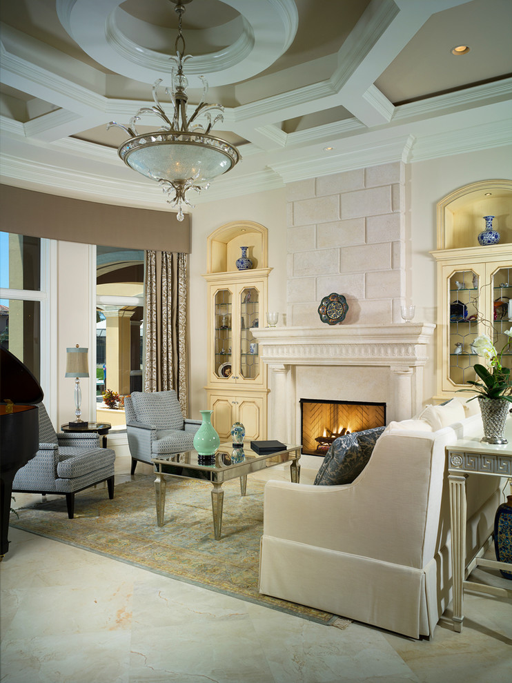 Exemple d'un salon exotique avec un sol en marbre, une cheminée standard et un manteau de cheminée en pierre.