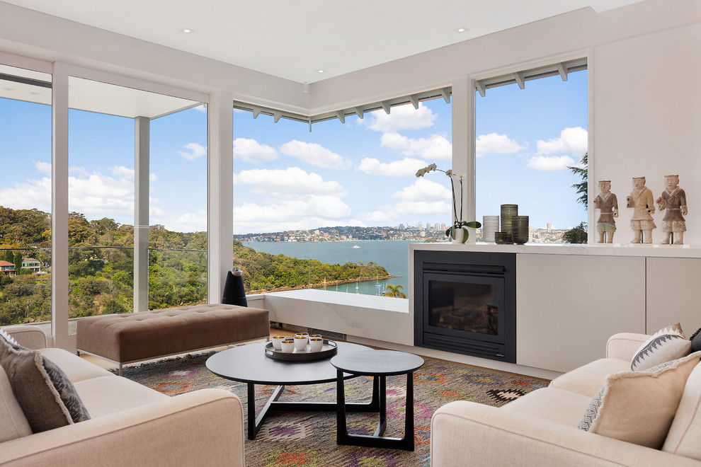 This is an example of a contemporary formal open plan living room in Sydney with a standard fireplace and no tv.
