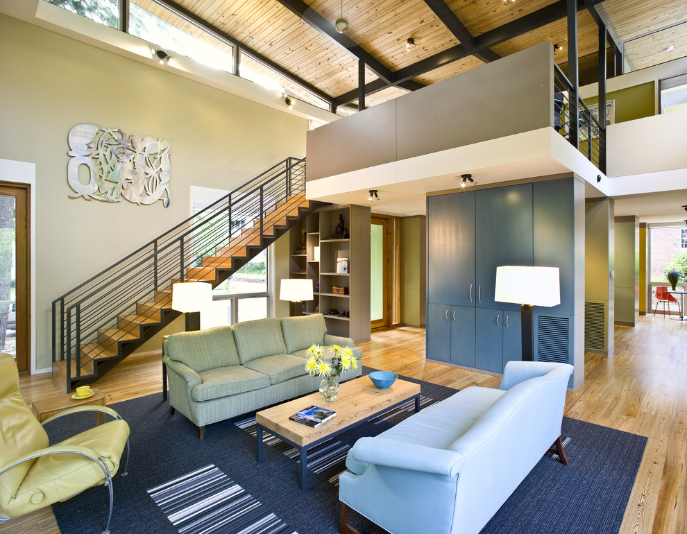 Идея дизайна: открытая гостиная комната в современном стиле с зелеными стенами, паркетным полом среднего тона и ковром на полу
