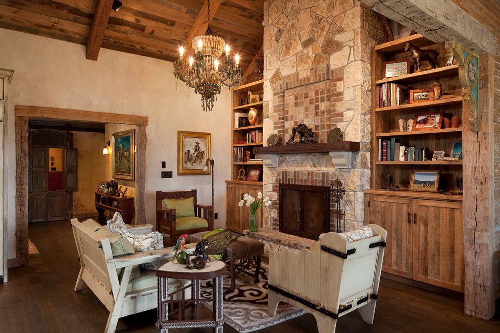 This is an example of a rustic living room in Austin with a brick fireplace surround.