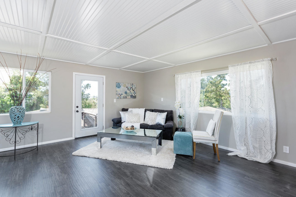 Photo of a small farmhouse open plan living room in San Diego with grey walls, ceramic flooring and grey floors.