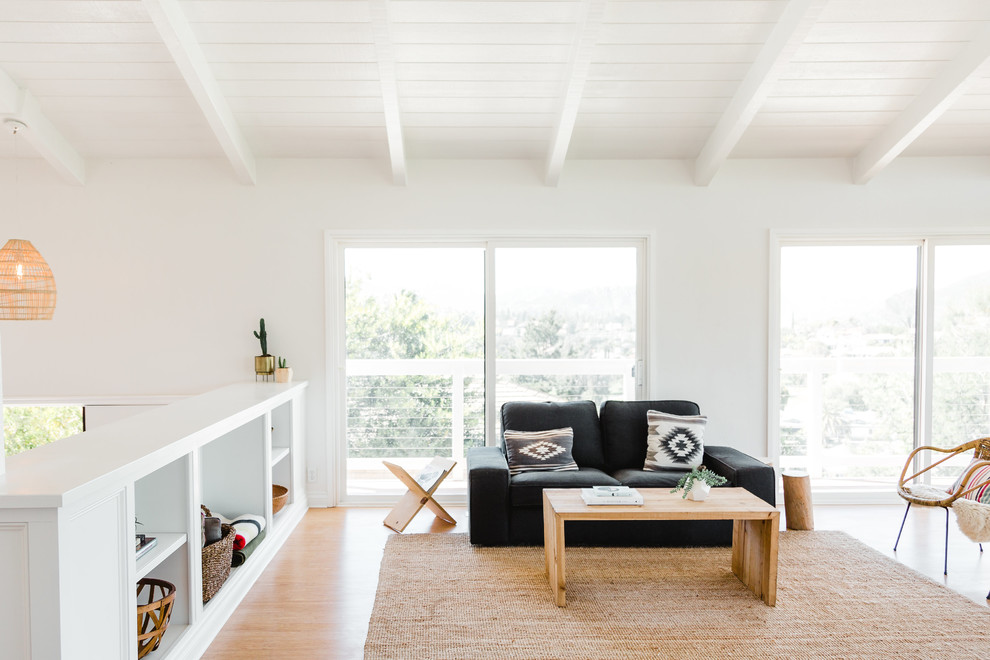 Medium sized scandinavian living room in San Diego with white walls.