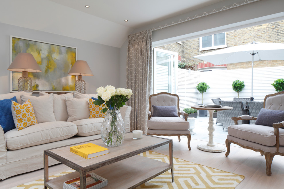 Inspiration for a transitional light wood floor living room remodel in London with gray walls