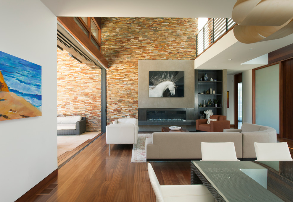 Exemple d'un grand salon tendance ouvert avec une cheminée ribbon, un sol en bois brun, un manteau de cheminée en métal et aucun téléviseur.