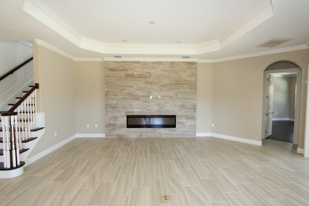 Design ideas for a large classic formal open plan living room in Orlando with beige walls, a ribbon fireplace, a tiled fireplace surround, beige floors, porcelain flooring and no tv.
