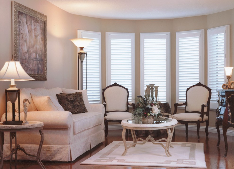 Medium sized traditional formal enclosed living room in Toronto with beige walls and medium hardwood flooring.