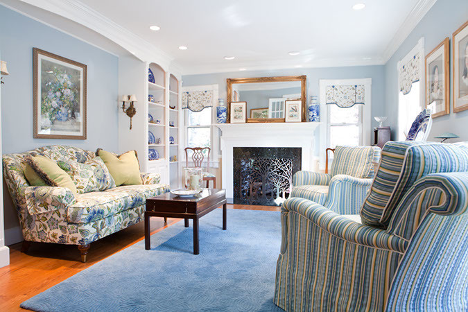 Living room - mid-sized traditional formal and enclosed medium tone wood floor living room idea in Bridgeport with blue walls, a standard fireplace and a metal fireplace