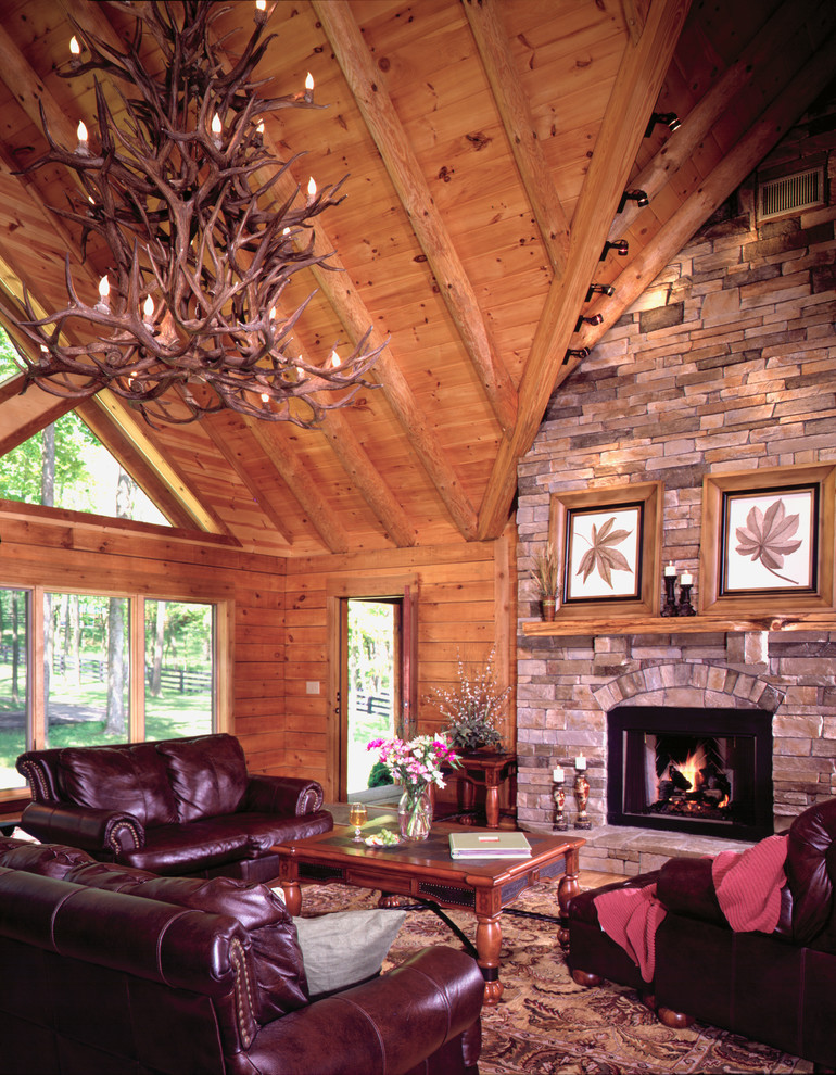 Inspiration for a mid-sized rustic formal and loft-style medium tone wood floor living room remodel in Louisville with brown walls, a standard fireplace, a stone fireplace and no tv