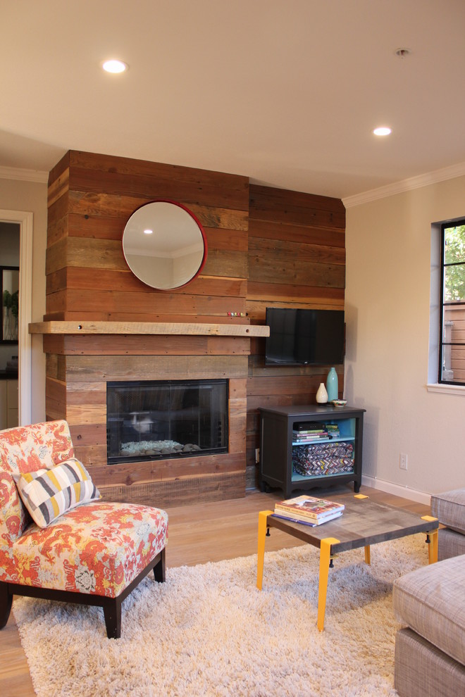 Example of a small mountain style light wood floor living room design in San Francisco with gray walls and a wall-mounted tv