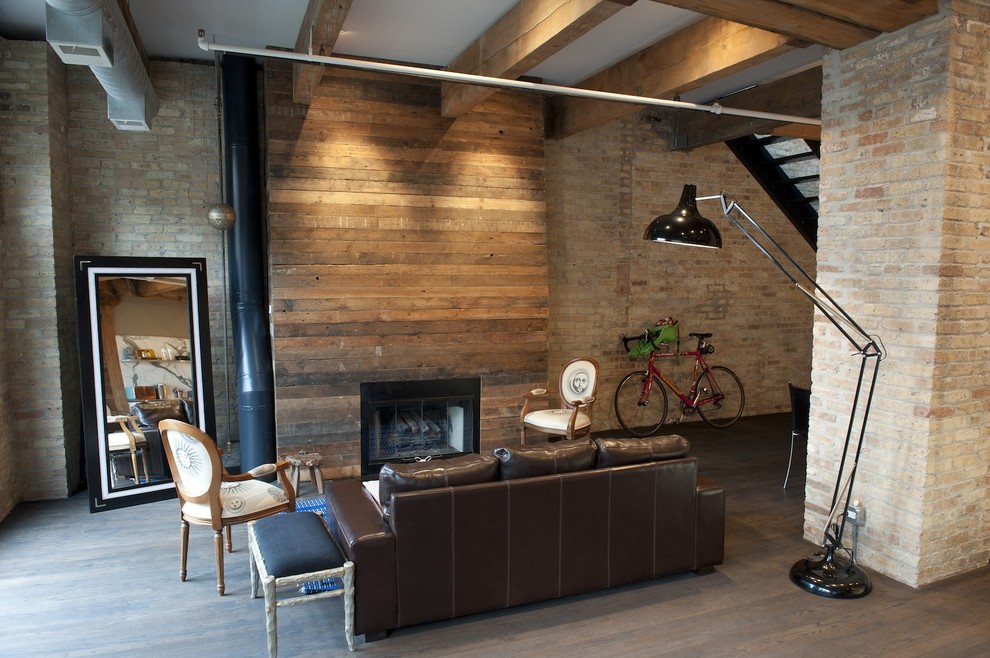 This is an example of a rustic living room in Chicago with a wooden fireplace surround and a standard fireplace.