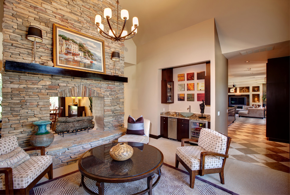 This is an example of a contemporary living room in Oklahoma City with a two-sided fireplace.