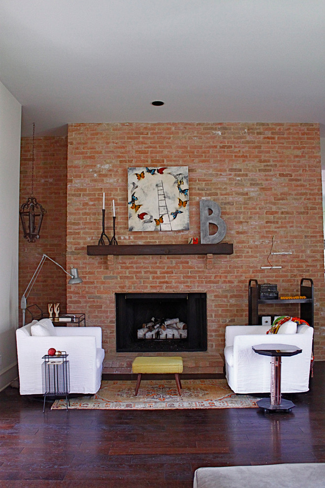 Inspiration for an industrial dark wood floor living room remodel in Austin with a standard fireplace and a brick fireplace