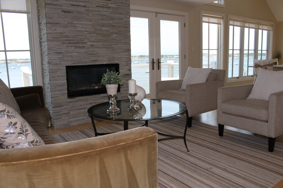 Medium sized coastal open plan living room in Boston with beige walls, a standard fireplace, a stone fireplace surround and no tv.