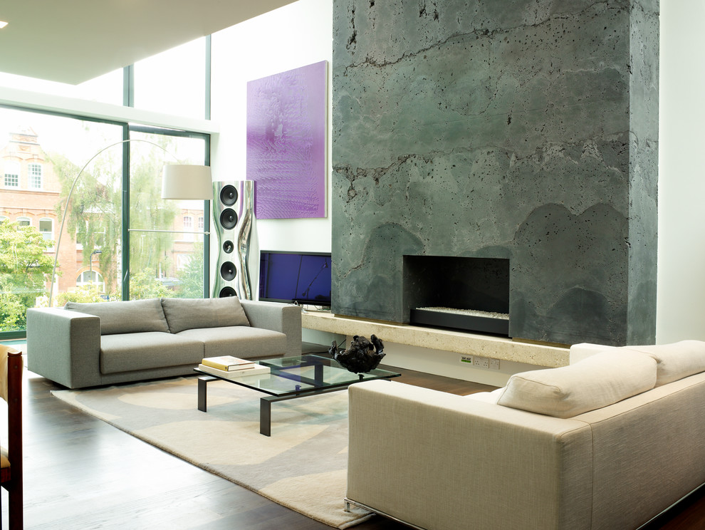 Inspiration for a contemporary open concept medium tone wood floor living room remodel in London with a standard fireplace, a concrete fireplace and a tv stand