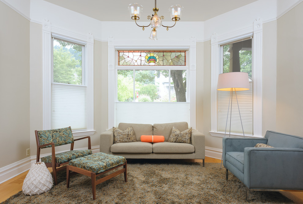 Esempio di un soggiorno moderno con pareti beige e pavimento in legno massello medio