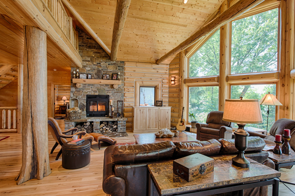 Example of a mountain style open concept medium tone wood floor living room design in Other with a standard fireplace and a stone fireplace