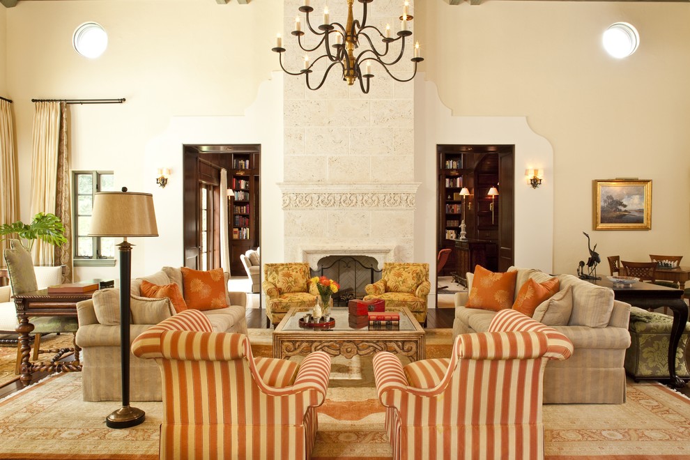 Design ideas for a mediterranean formal enclosed living room in Miami with beige walls, a standard fireplace and no tv.