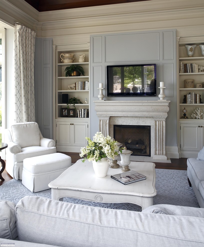 Living room - traditional living room idea in Burlington with blue walls and a wall-mounted tv