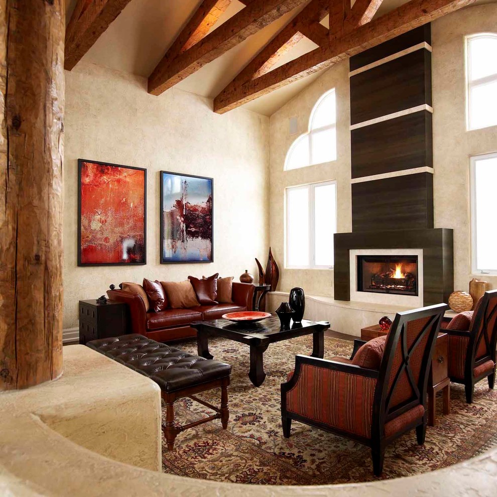 Exemple d'un salon montagne de taille moyenne et ouvert avec une salle de réception, un mur beige, une cheminée standard, aucun téléviseur, un sol en bois brun et un manteau de cheminée en bois.
