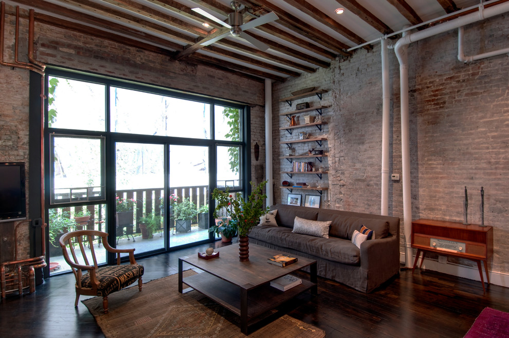 Inspiration for an industrial living room in New York with dark hardwood flooring.