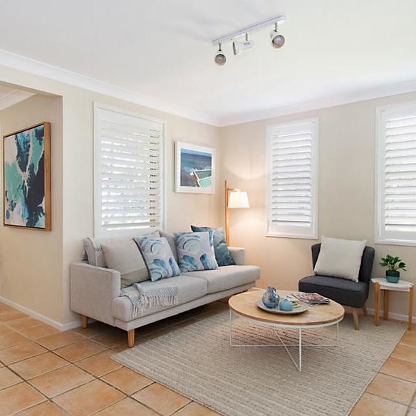 Medium sized nautical open plan living room in Gold Coast - Tweed with white walls, ceramic flooring and orange floors.