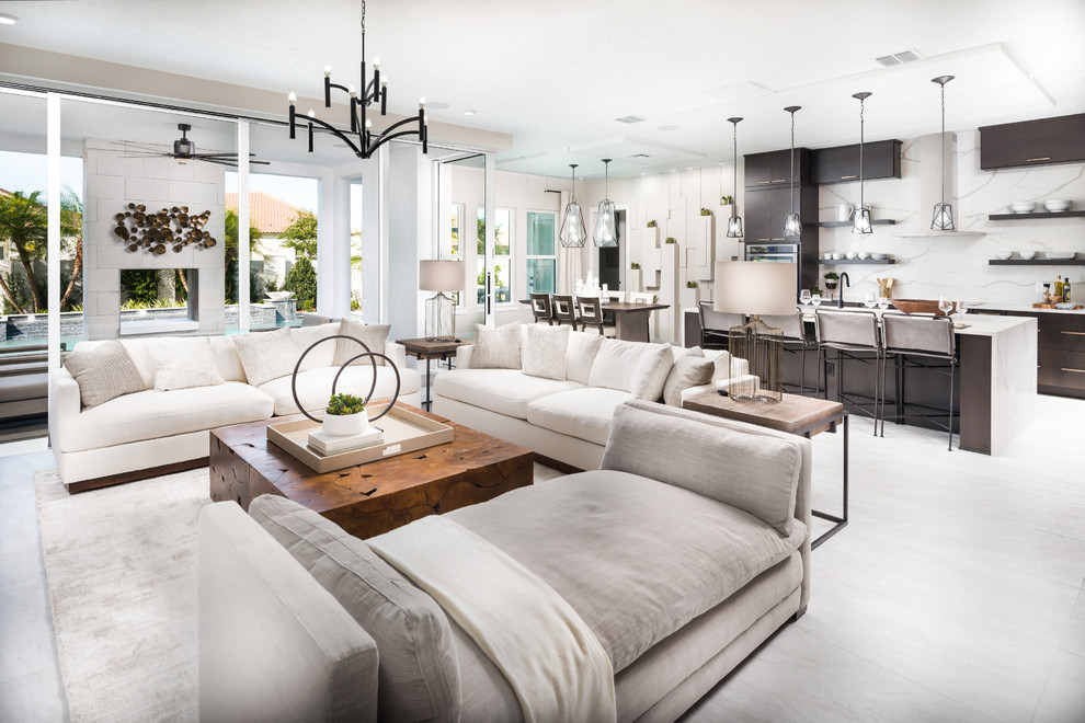 This is an example of a large contemporary open plan living room in Orlando with white floors and feature lighting.