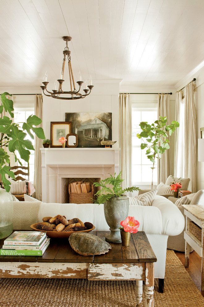 Example of a country living room design in Atlanta with a standard fireplace and no tv