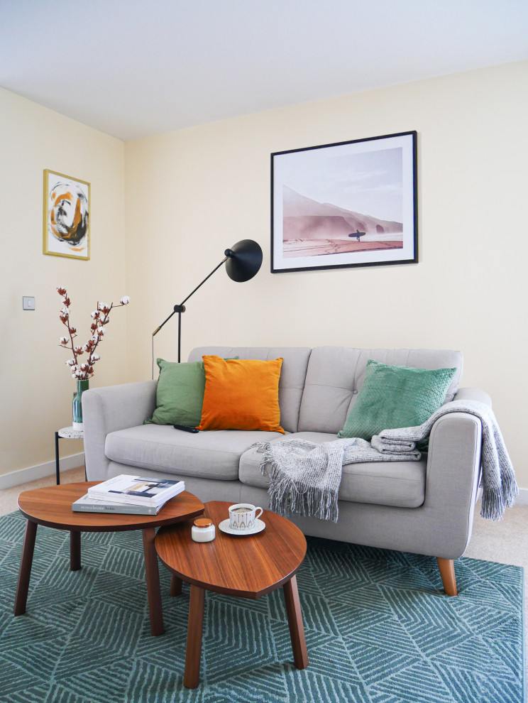 Design ideas for a medium sized scandinavian open plan living room in Edinburgh with yellow walls, carpet, no fireplace, a freestanding tv and beige floors.
