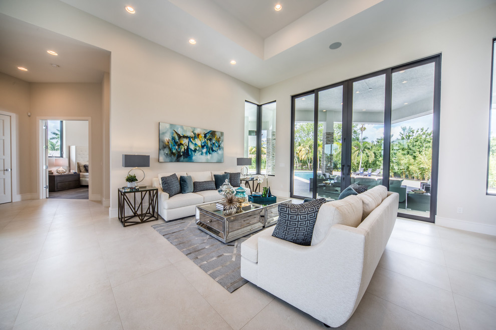 Example of a mid-sized trendy open concept ceramic tile and white floor living room design in Miami with white walls, a standard fireplace and a stone fireplace