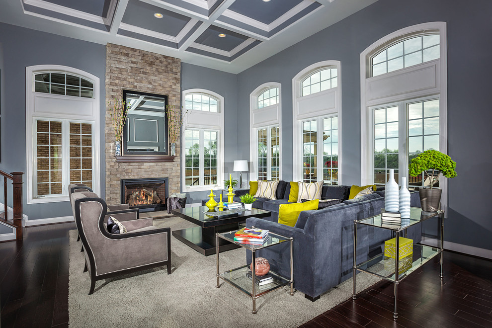 Example of a large transitional open concept medium tone wood floor living room design in DC Metro with a standard fireplace, a stone fireplace and gray walls