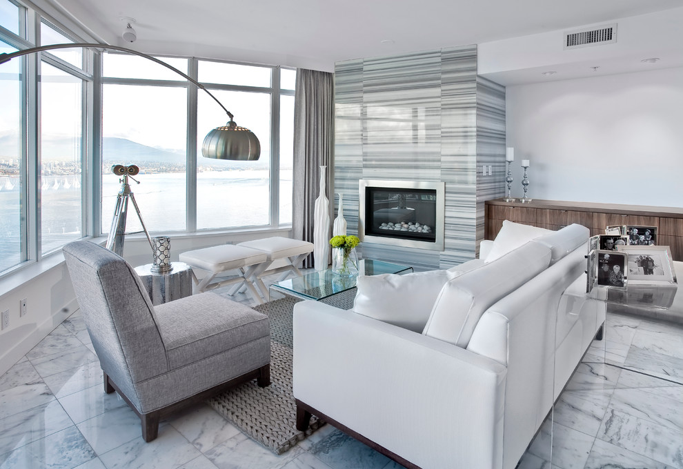 Contemporary living room in Vancouver with white walls, a standard fireplace and marble flooring.