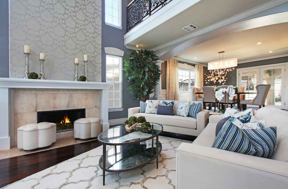 Photo of a coastal open plan living room in Orange County with grey walls, dark hardwood flooring, a standard fireplace and a stone fireplace surround.