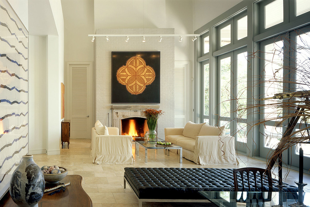 Photo of a large contemporary formal living room in New Orleans with beige walls, a standard fireplace and no tv.