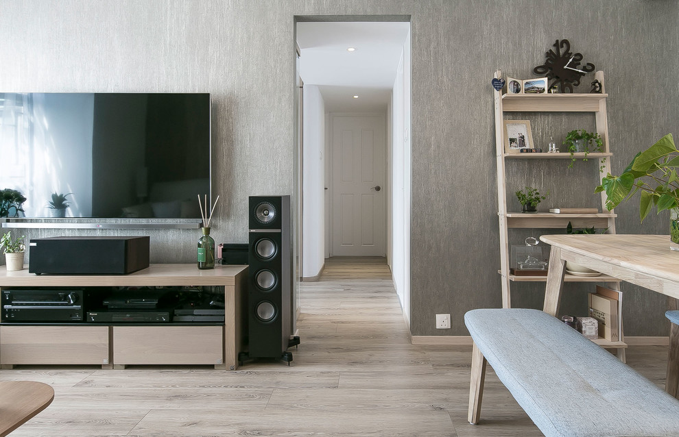 Photo of a small contemporary open plan living room in Hong Kong with grey walls, laminate floors, a wall mounted tv and beige floors.