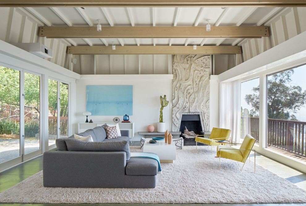 This is an example of a midcentury open plan living room in San Francisco with white walls and a standard fireplace.