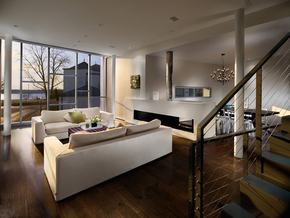 Immagine di un grande soggiorno minimal aperto con sala formale, pavimento in cemento, camino lineare Ribbon e TV a parete