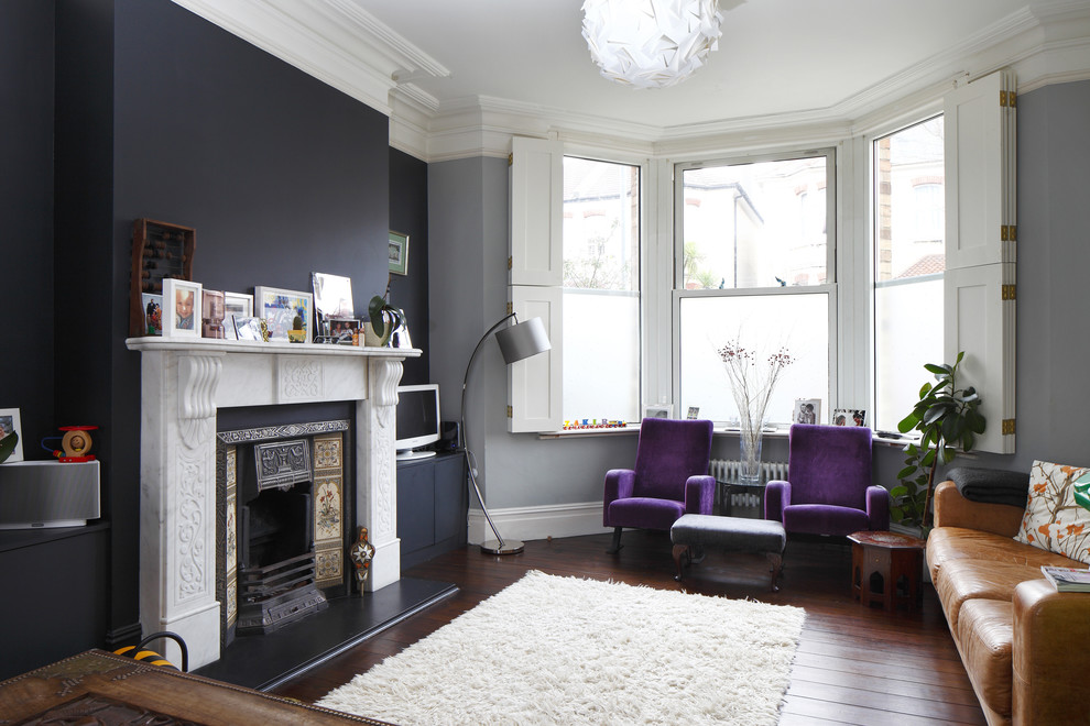 Medium sized scandi formal enclosed living room in Sussex with blue walls, dark hardwood flooring, a standard fireplace, a stone fireplace surround and a freestanding tv.