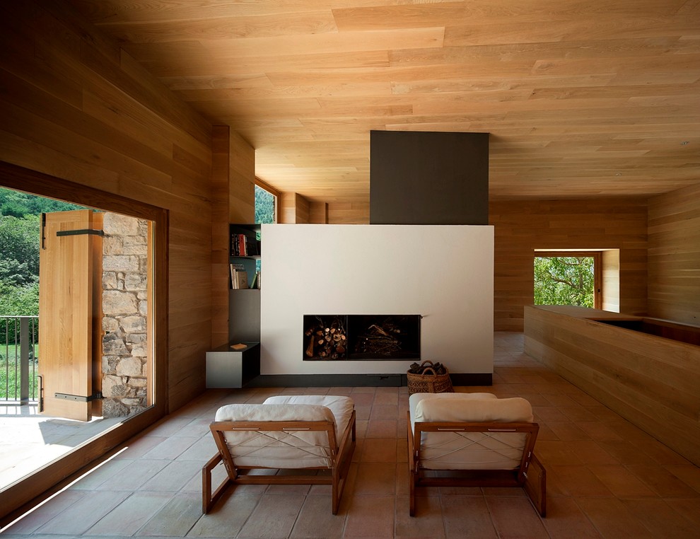 This is an example of a medium sized modern formal open plan living room in Barcelona with brown walls, terracotta flooring, a standard fireplace, no tv and a plastered fireplace surround.