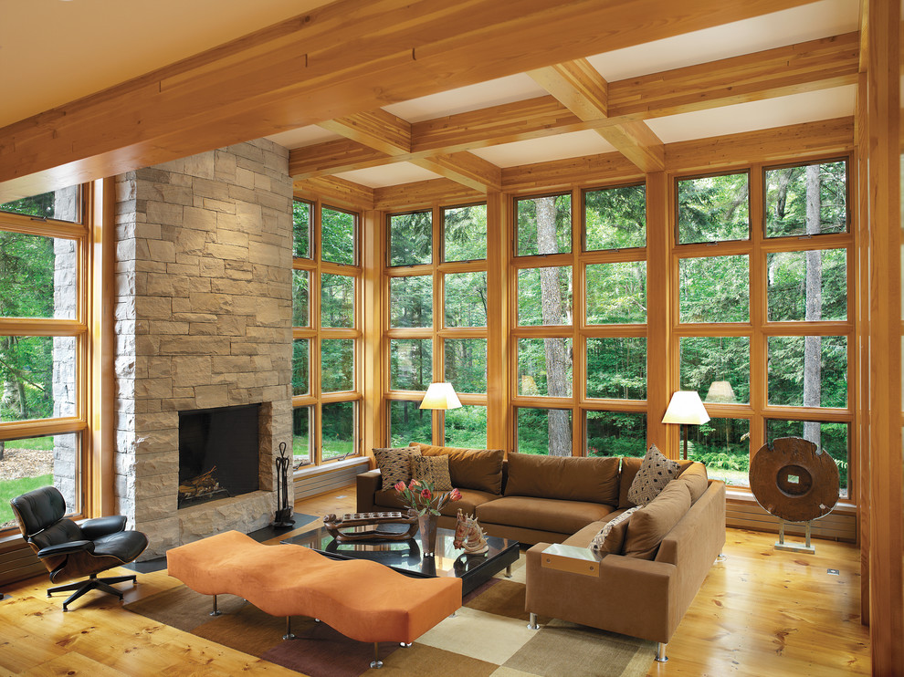 This is an example of a contemporary living room in Burlington with a standard fireplace and a stone fireplace surround.