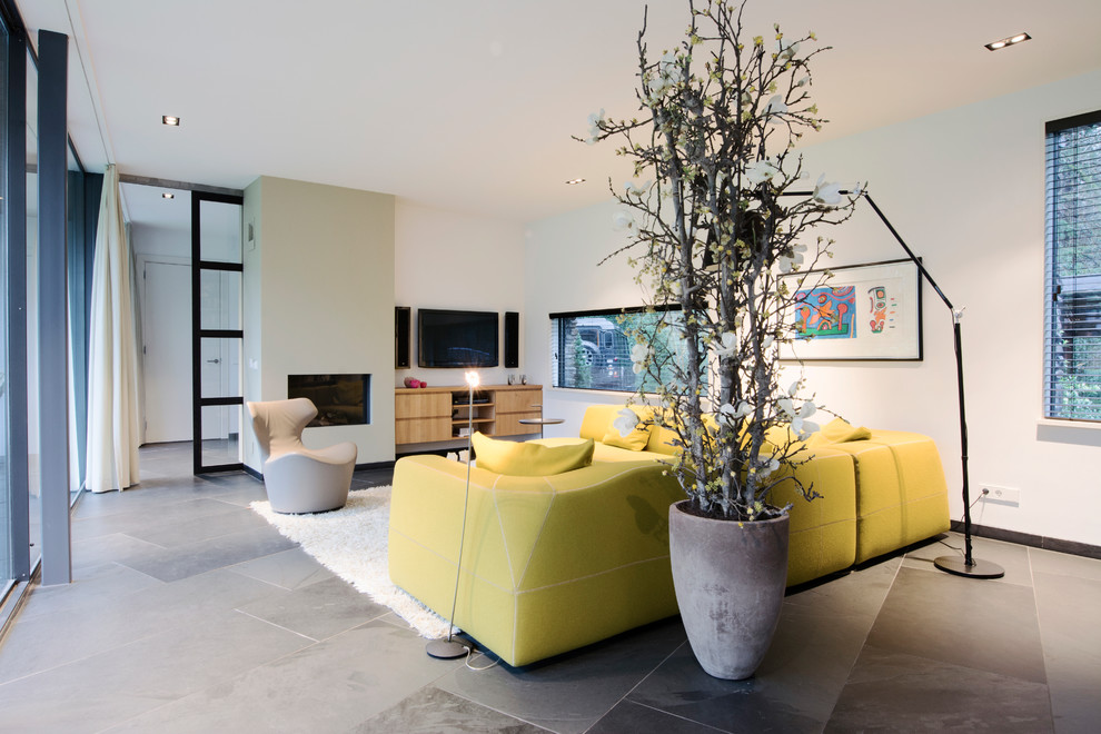 Photo of a large contemporary open plan living room in Amsterdam with white walls, ceramic flooring and a concealed tv.