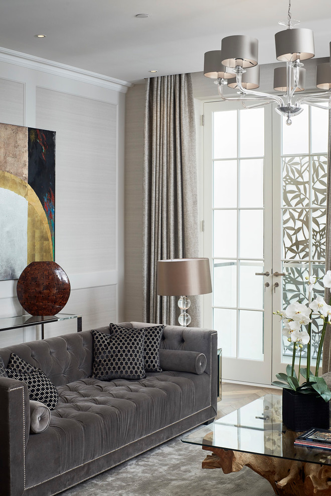 Example of a transitional formal living room design in London with gray walls