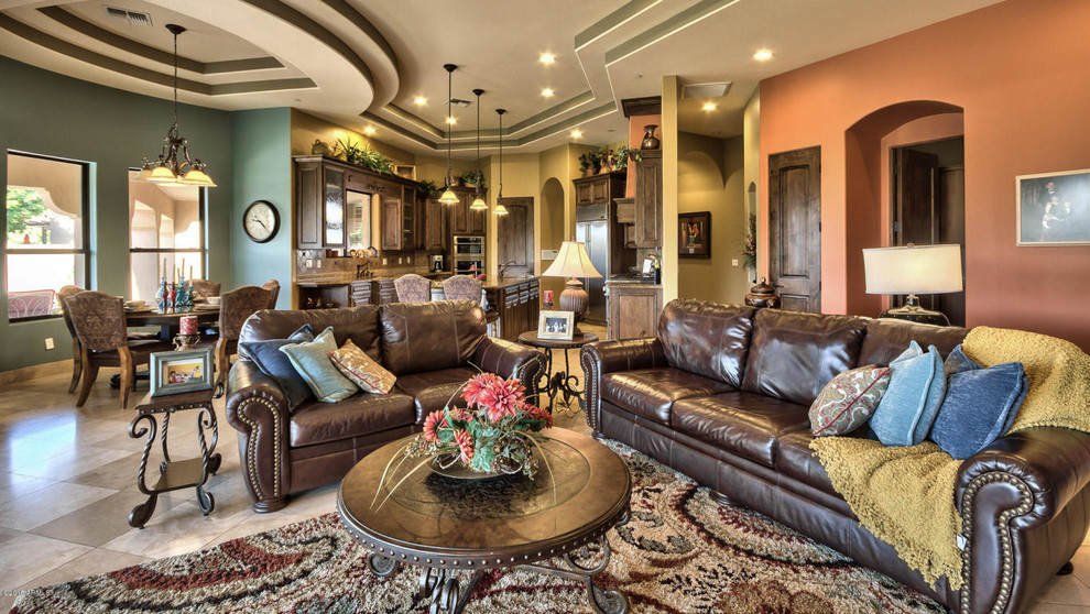 This is an example of a large mediterranean open plan living room in Phoenix with multi-coloured walls, ceramic flooring, no fireplace and beige floors.