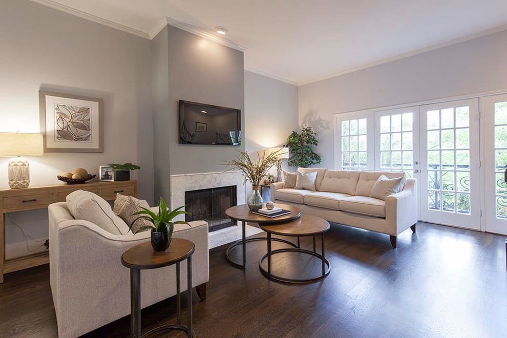 Example of a small dark wood floor living room design in Houston with gray walls, a standard fireplace, a stone fireplace and a wall-mounted tv