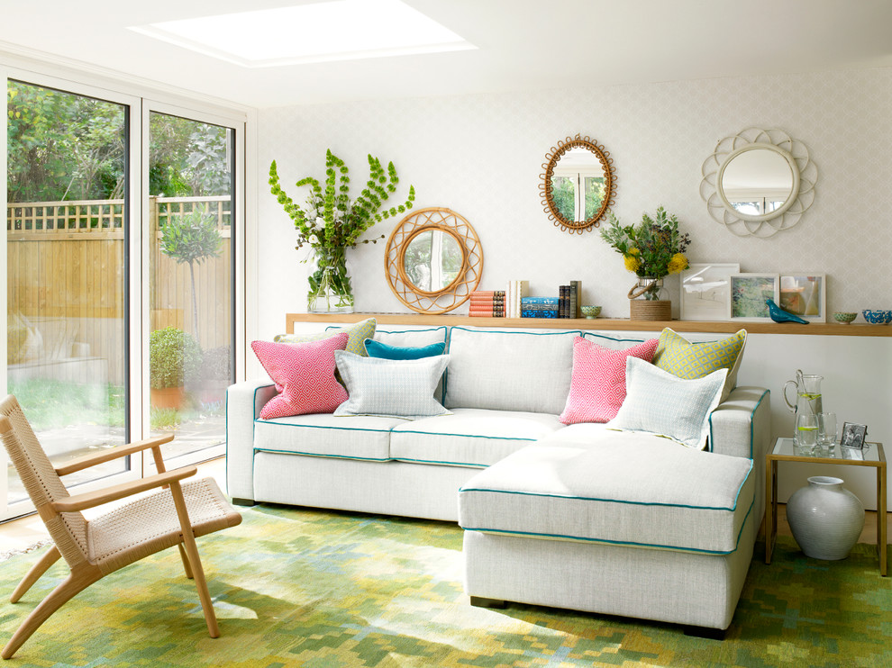 Example of a trendy green floor living room design in London with white walls