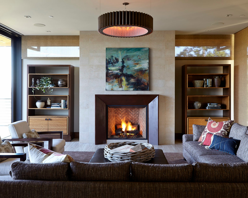 Photo of a medium sized contemporary open plan living room in San Francisco with a tiled fireplace surround, a standard fireplace, beige walls, light hardwood flooring, no tv and grey floors.