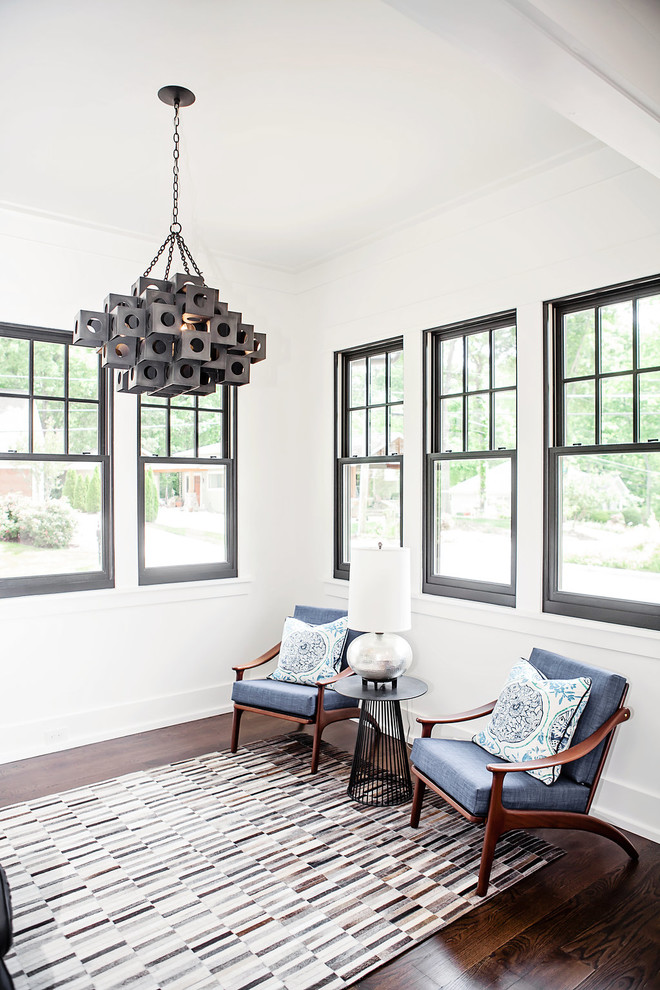 This is an example of a scandinavian open plan living room in Charlotte with white walls and dark hardwood flooring.