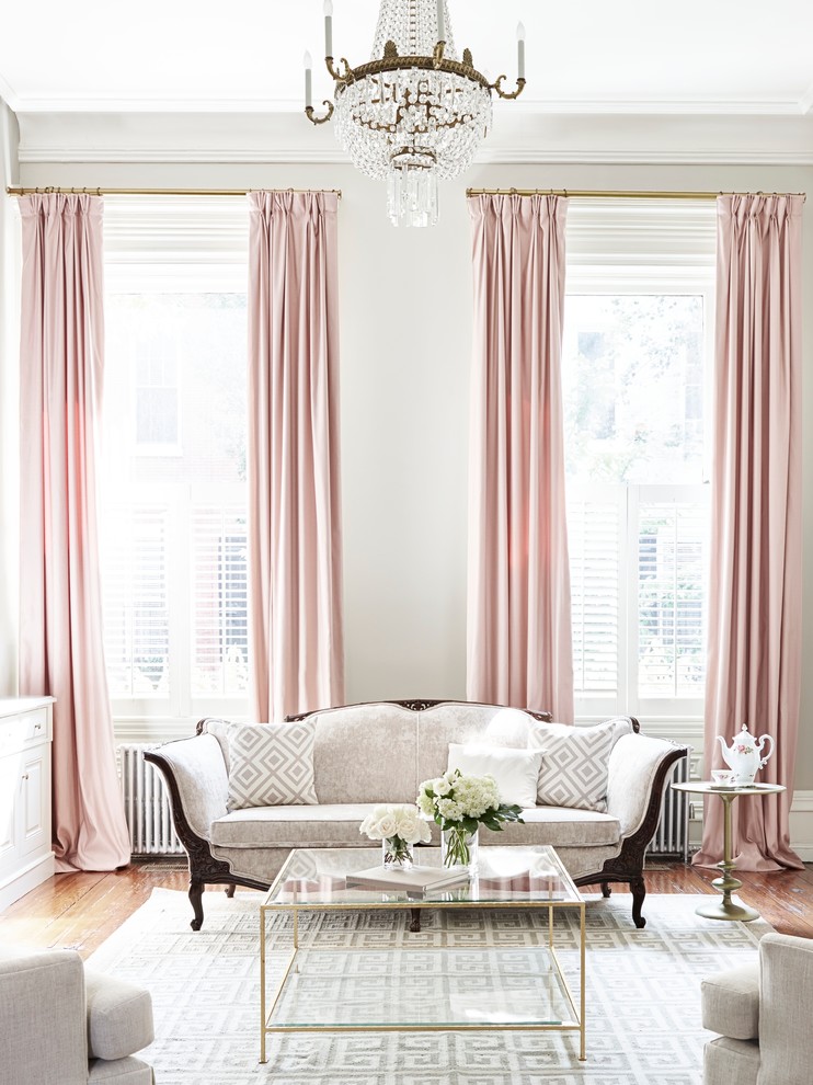 Example of a classic medium tone wood floor living room design in Philadelphia with white walls
