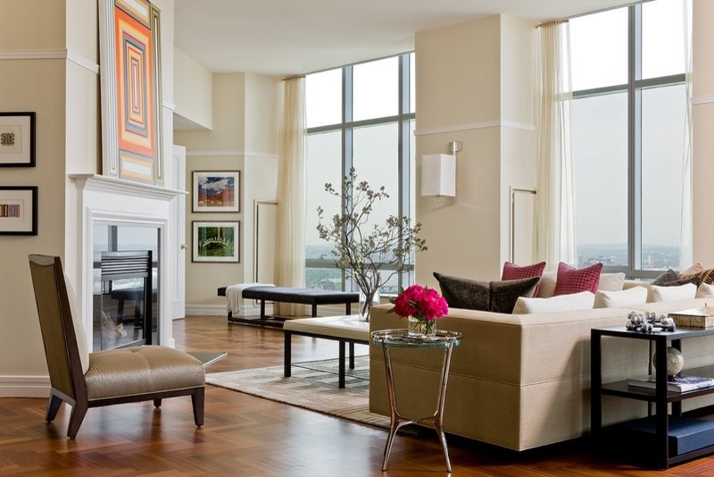 Example of a large trendy formal and open concept medium tone wood floor living room design in Boston with beige walls, a standard fireplace and a stone fireplace